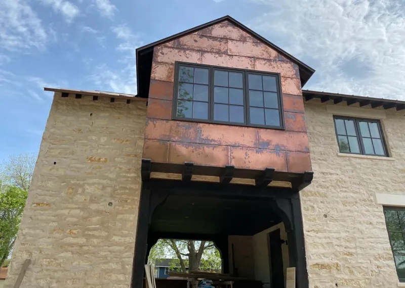 Copper metal panel facade on a stone building for Skylight Installation in Harwood Heights